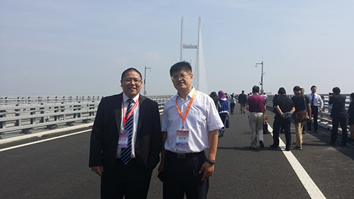 在东博会的安排下董旭麟与嘉宾一同考察在建中的新鸭绿江大桥图为董旭麟与辽宁省外事办公室港澳处处长李曙光合照